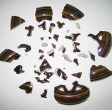 We reassembled, filled, created missing areas, painted and glazed this pottery lid that was broken in approximately 45 pieces. Pottery Repair & Restoration Service at Sundog Restoration Studio